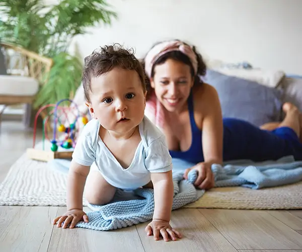 Mother and baby engaging in therapy session at home