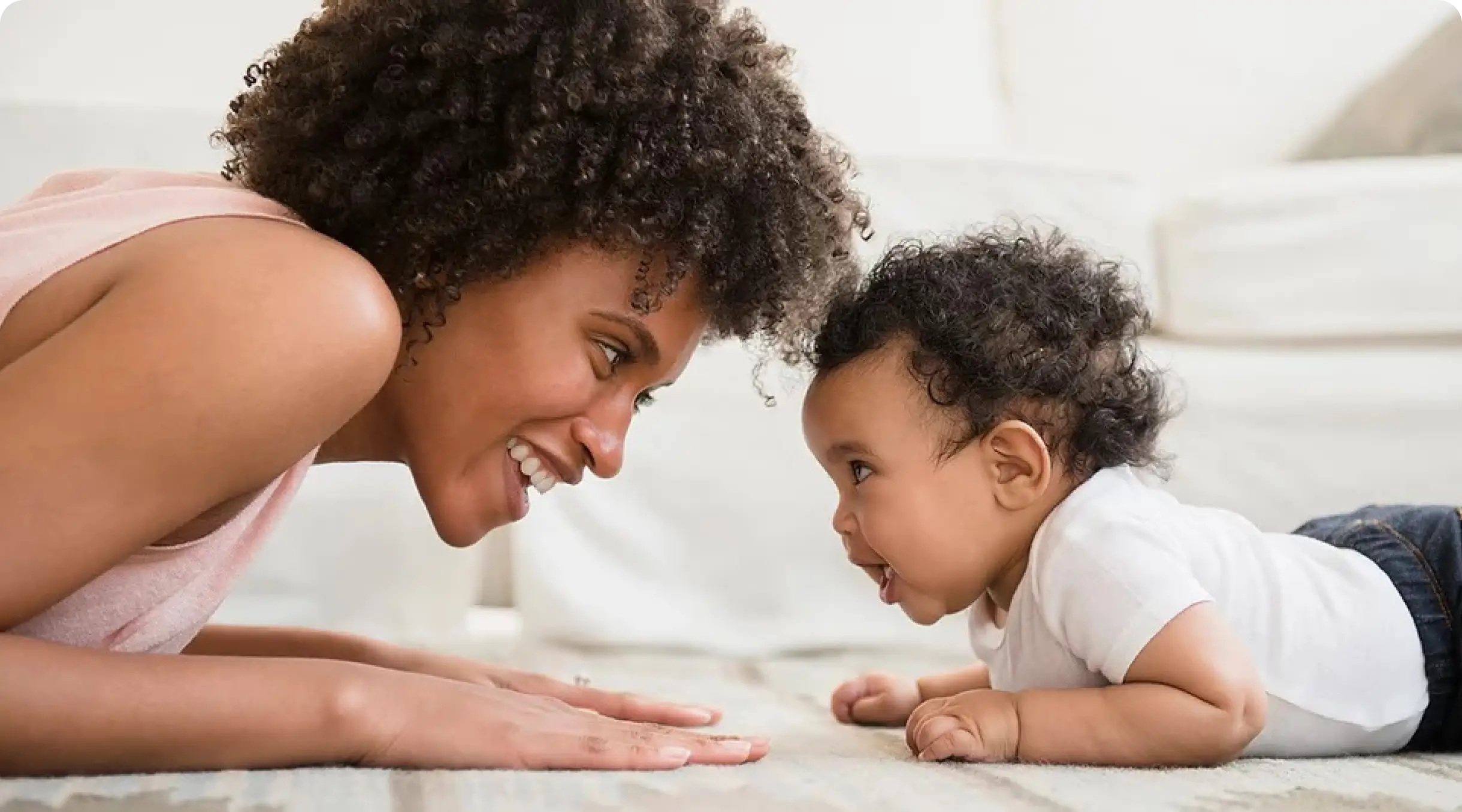 Smiling mother and baby face-to-face, fostering connection